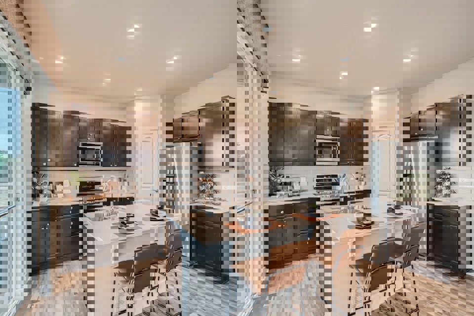 A kitchen with a table and chairs.