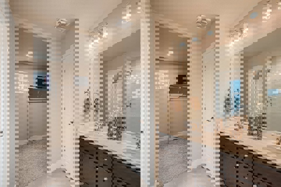 A bathroom with a large mirror.