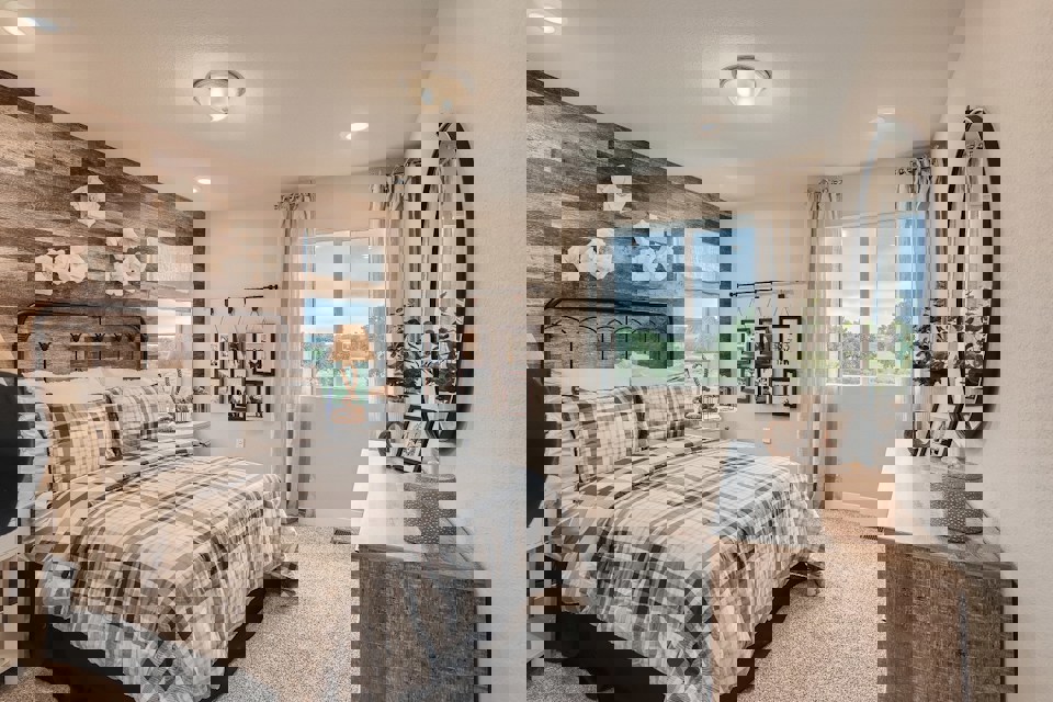 A bedroom with a bed and a mirror.