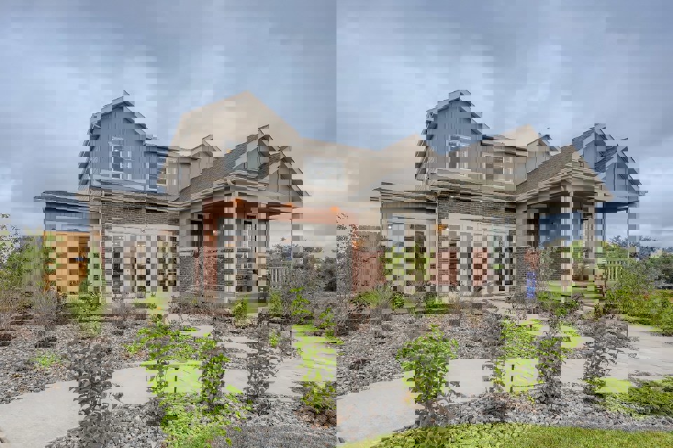 A house with a gravel driveway.