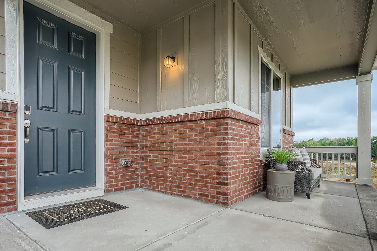 A brick building with a patio and a couch.