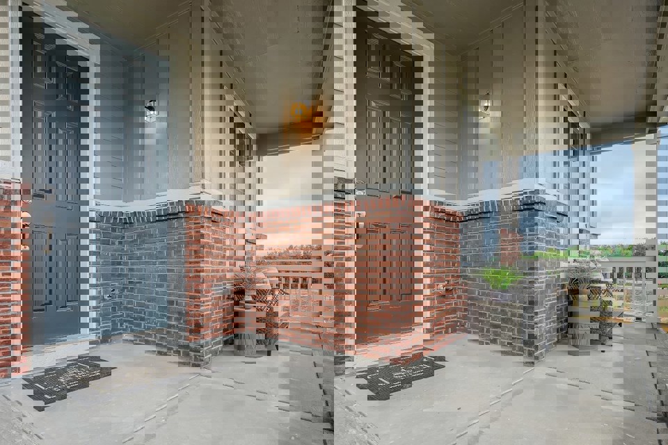 A brick building with a patio and a couch.