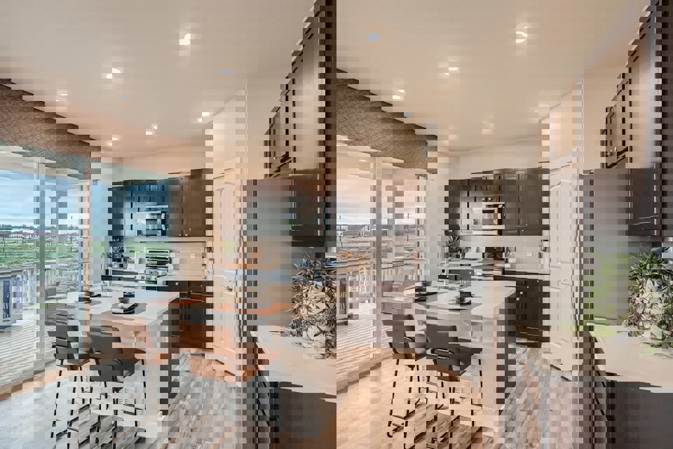 A kitchen with a table and chairs.