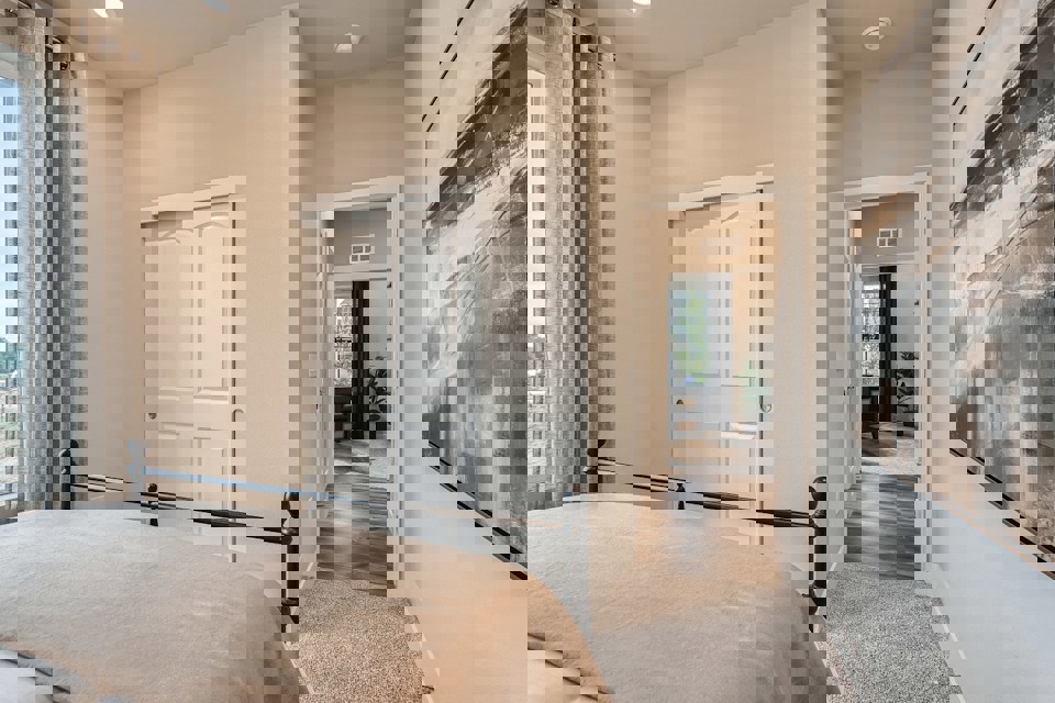 A bedroom with a bed and a door.