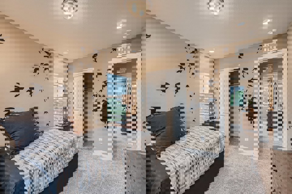 A bedroom with a bed and a table.