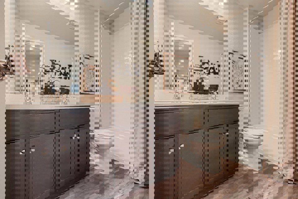 A bathroom with a large mirror.