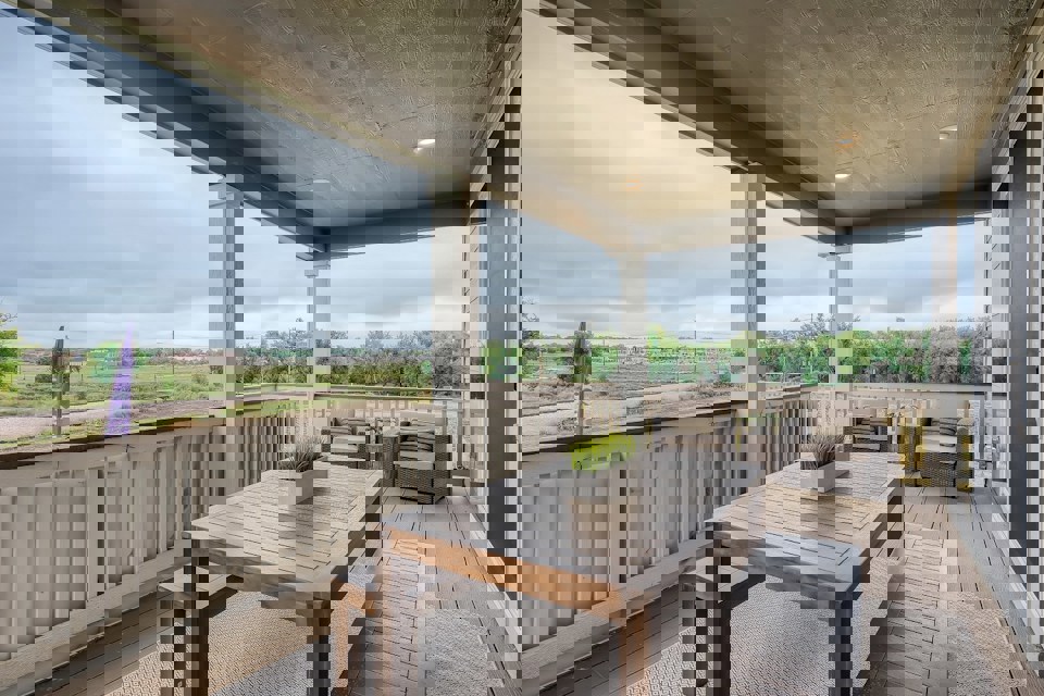 A table and chairs on a deck.