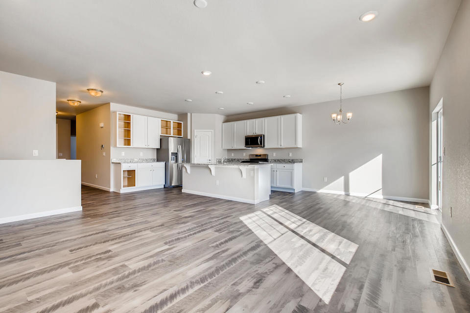 A large kitchen with white cabinets.