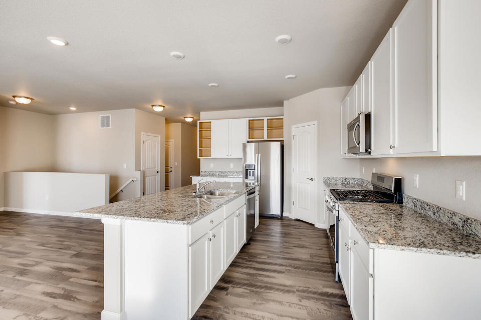 A kitchen with white cabinets.
