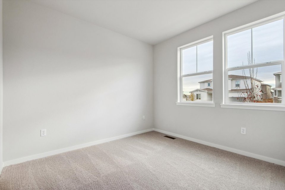 A room with a window and a carpet.