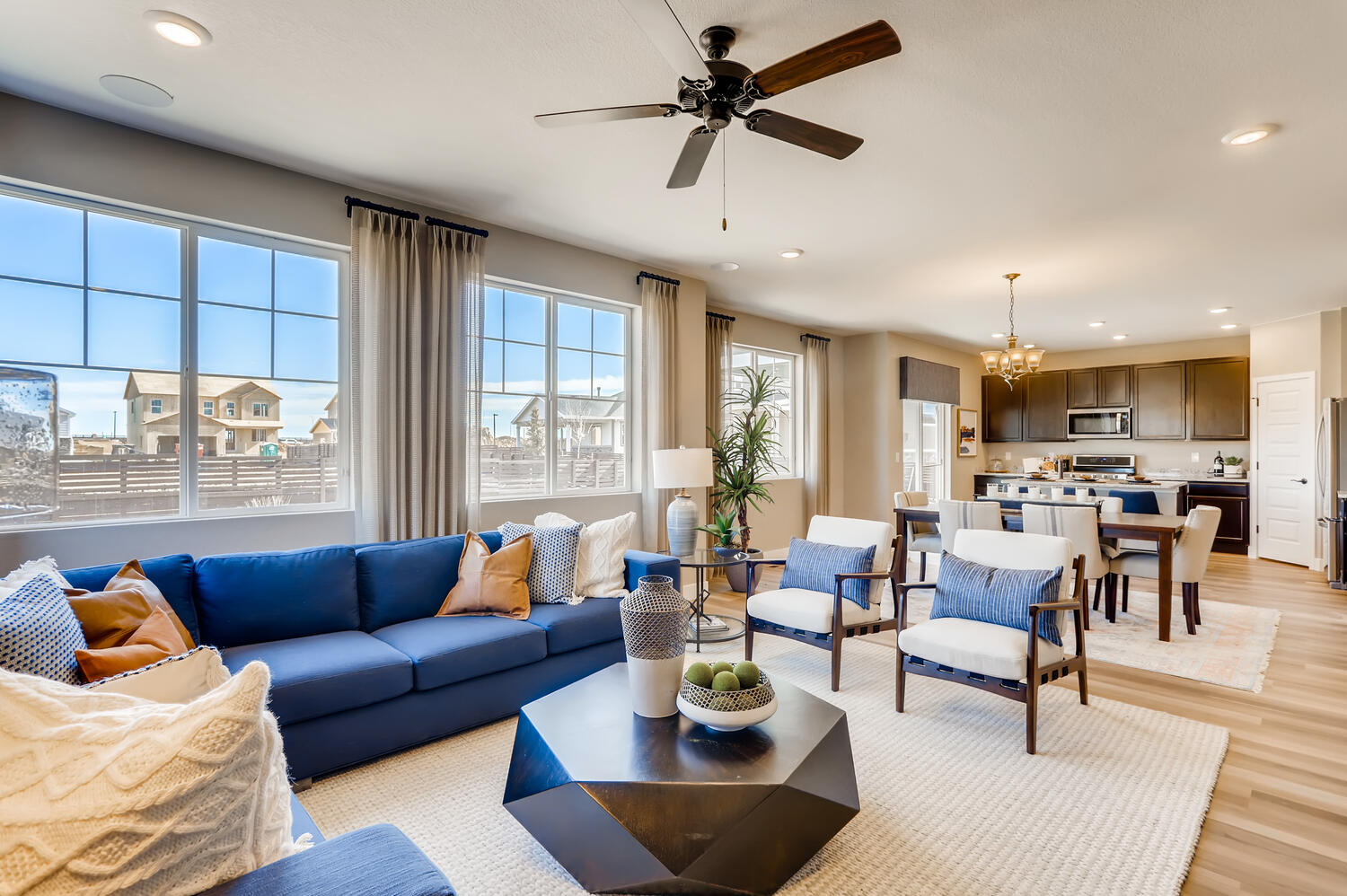 A living room with a blue couch and a table.