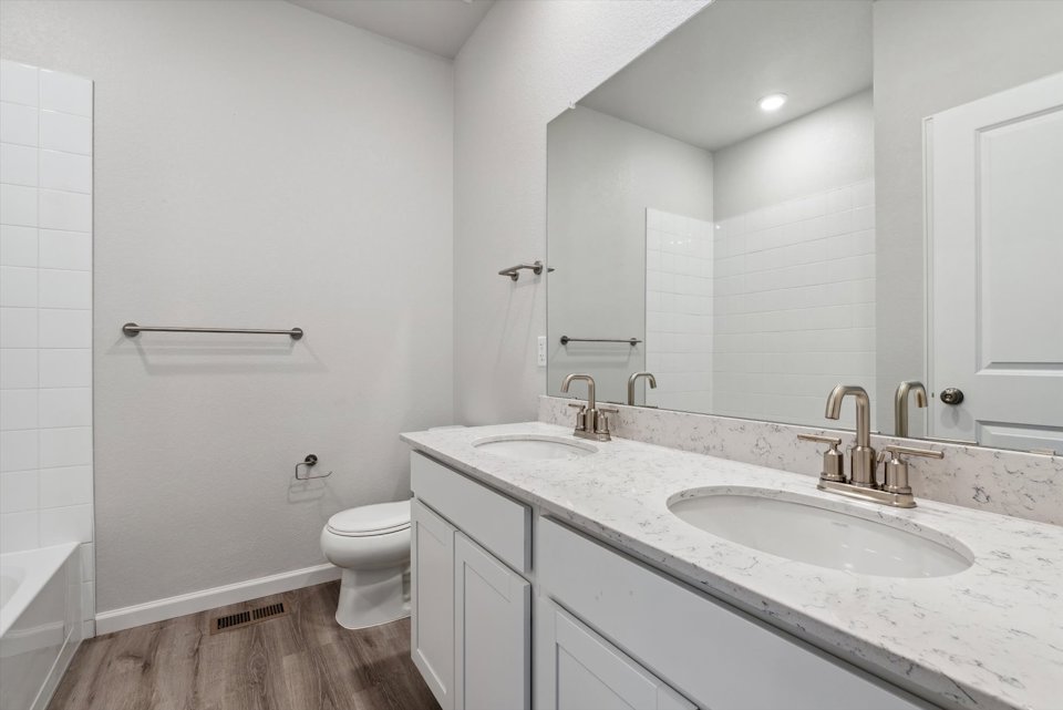 A bathroom with a sink toilet and a bathtub.