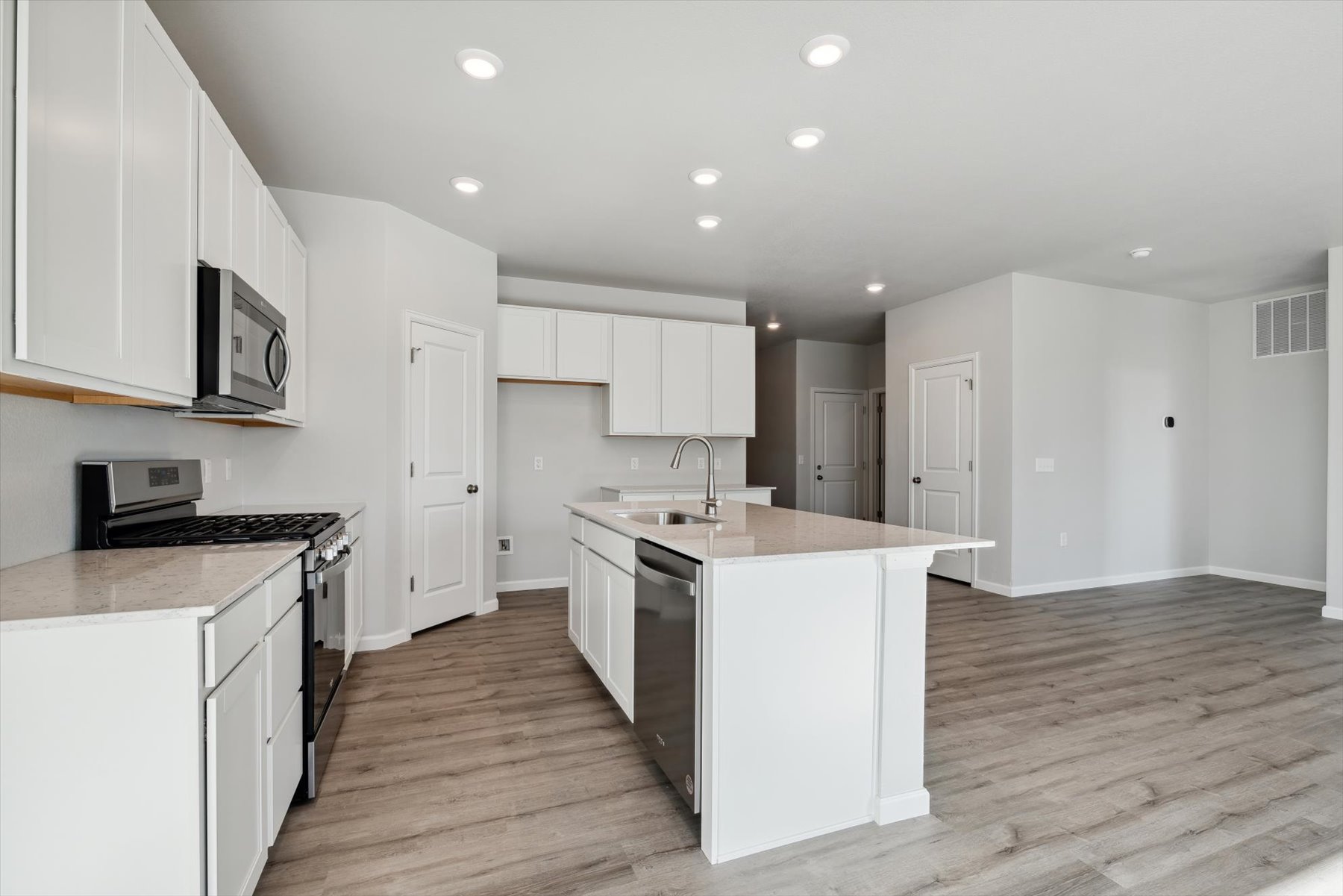 A kitchen with white cabinets.