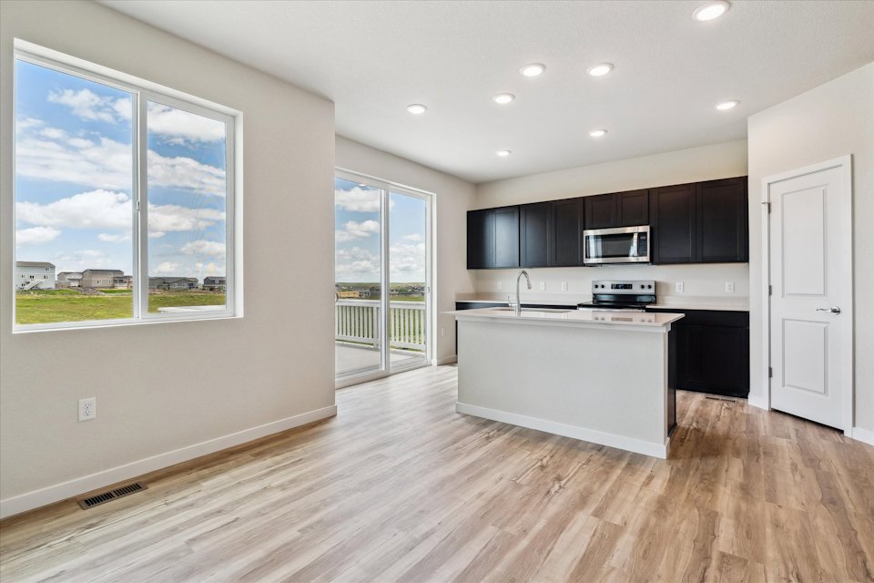 A kitchen with a wood floor.