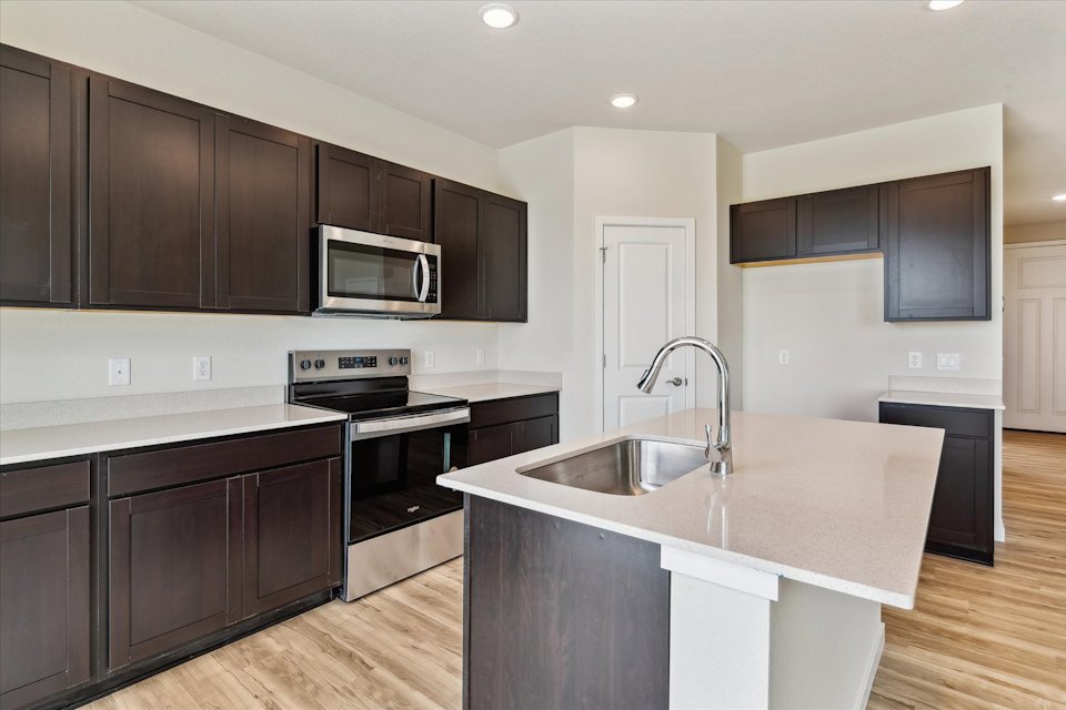 A kitchen with black cabinets.