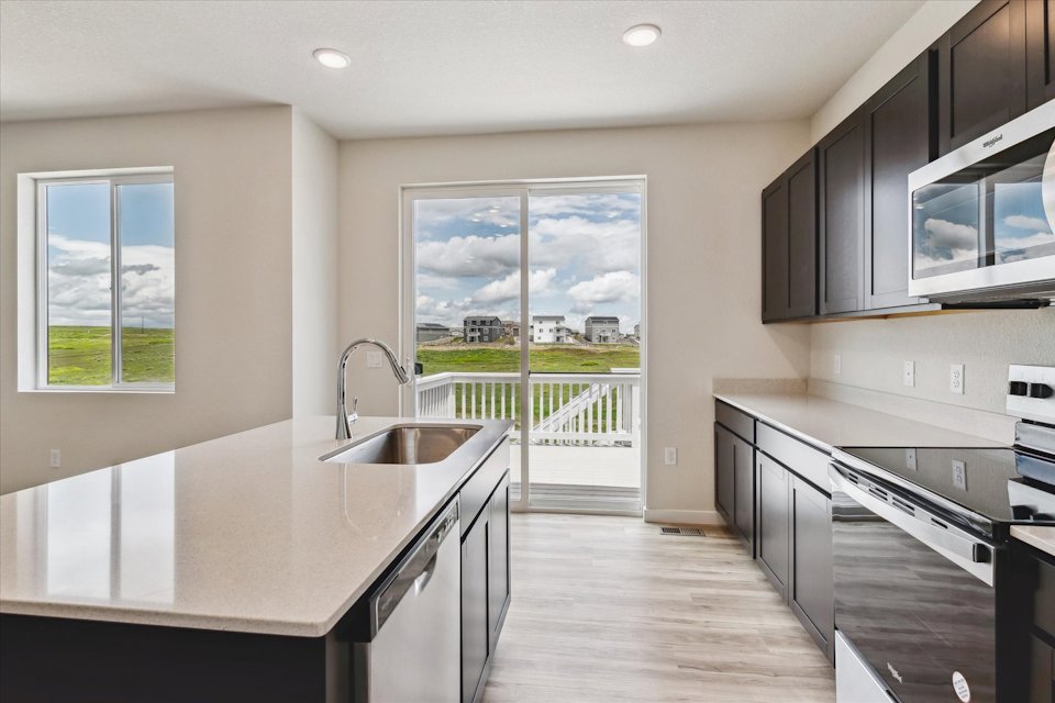 A kitchen with a large window.