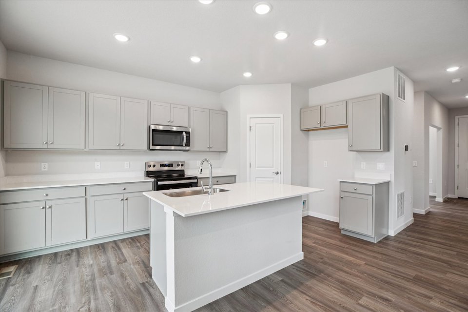 A kitchen with white cabinets.