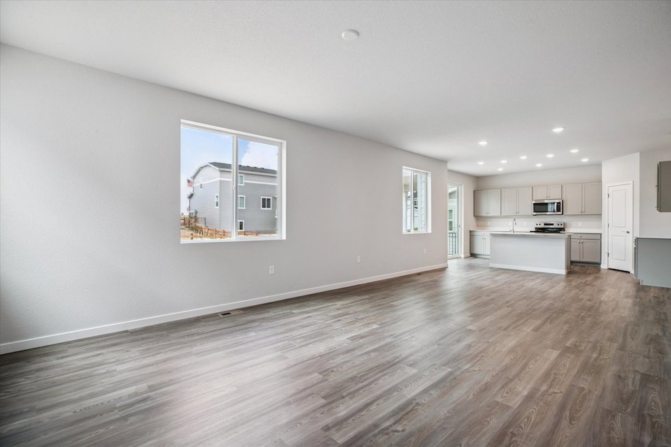 A large empty room with a wood floor.