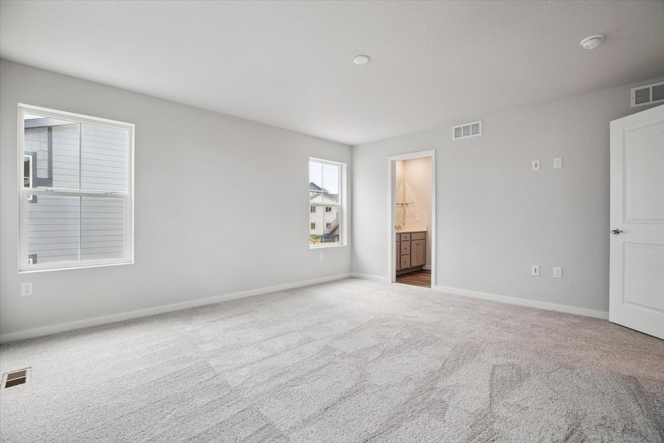A room with white walls and a door.