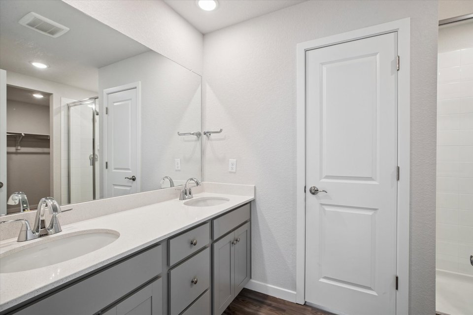 A bathroom with white cabinets.