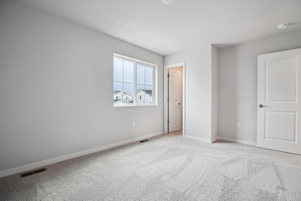 A room with a window and a door.