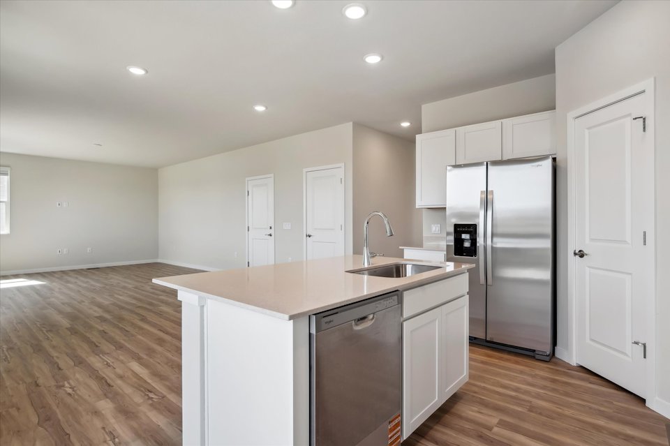 A kitchen with white cabinets.