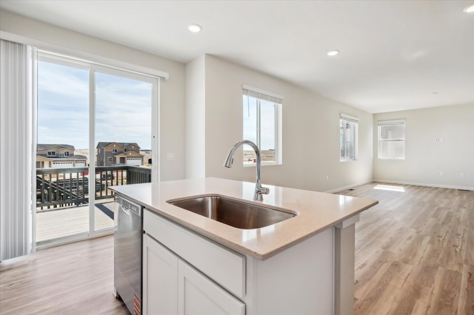 A kitchen with a large window.