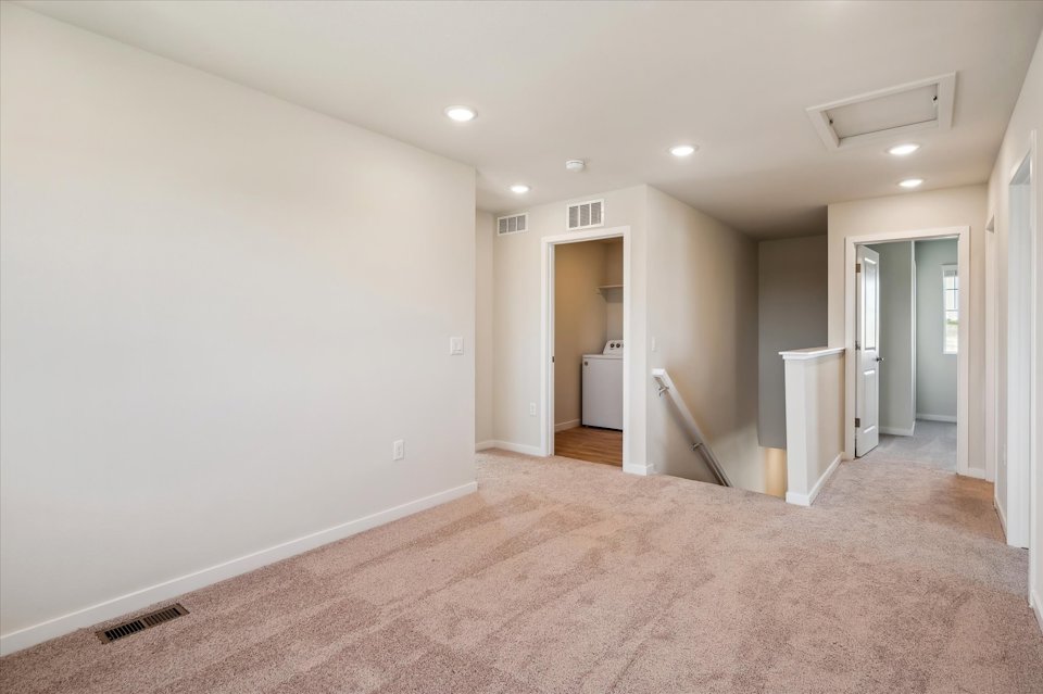 A hallway with white walls.