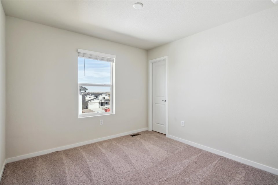 A room with a window and a door.