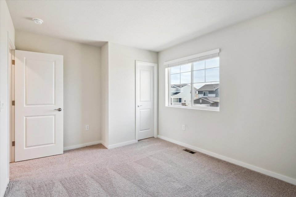 A room with white walls and a window.