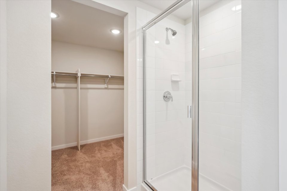 A shower with a glass door.