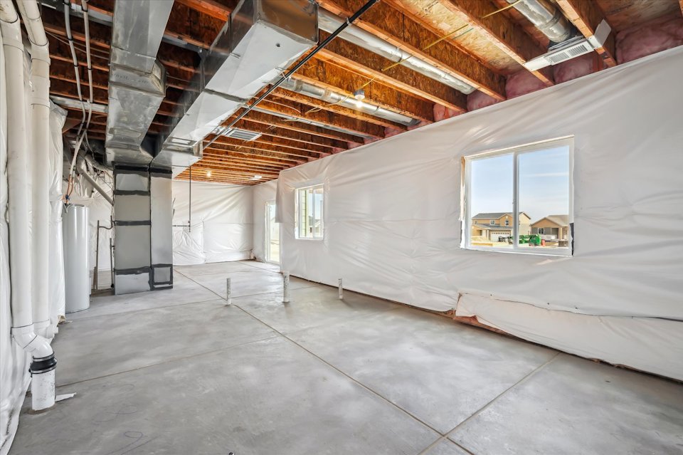 A room with a window and a white wall.