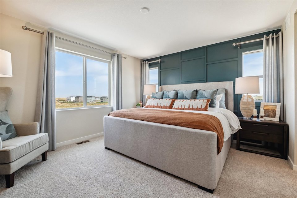 A bedroom with a bed and a couch.