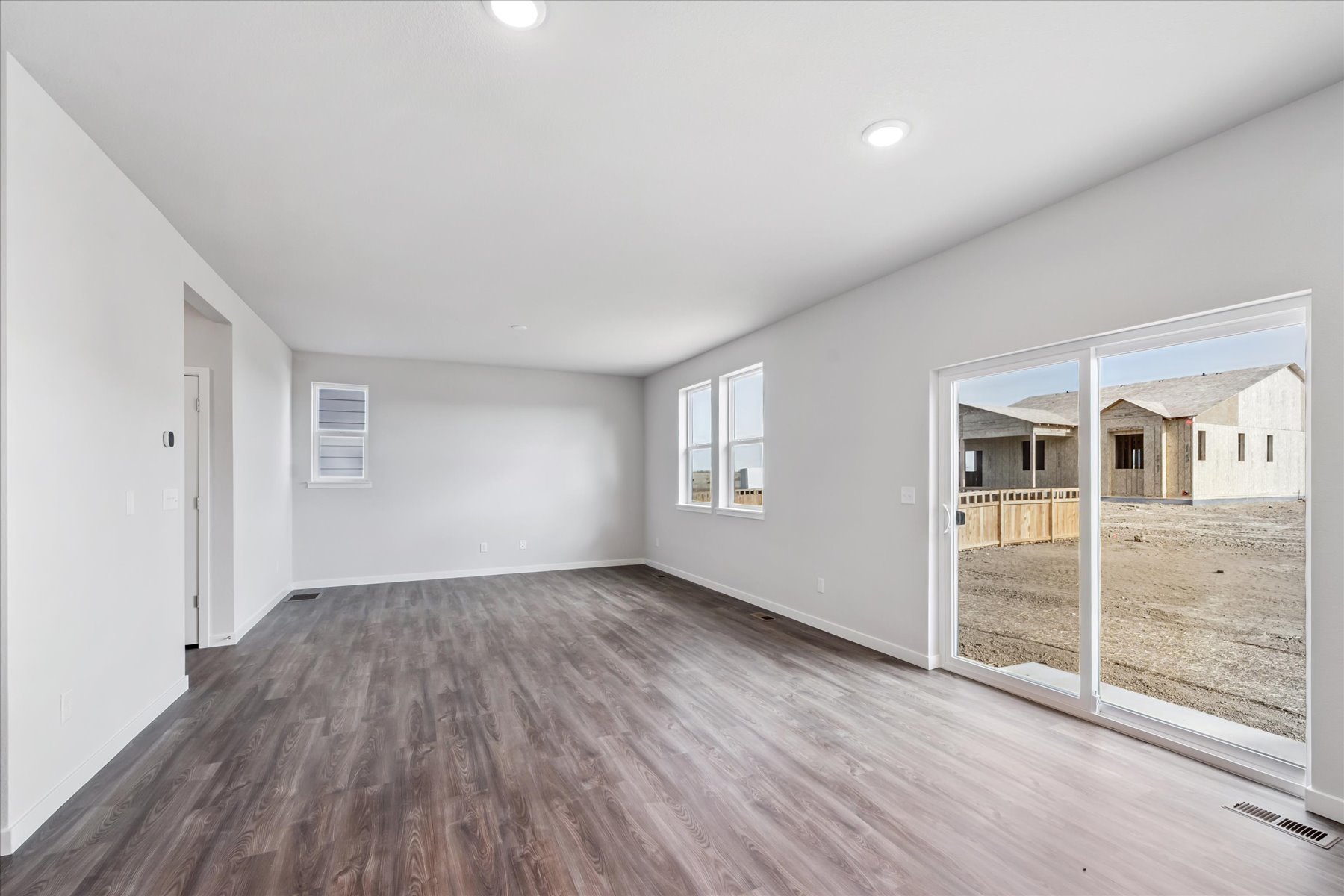 A room with a wood floor and a glass door.
