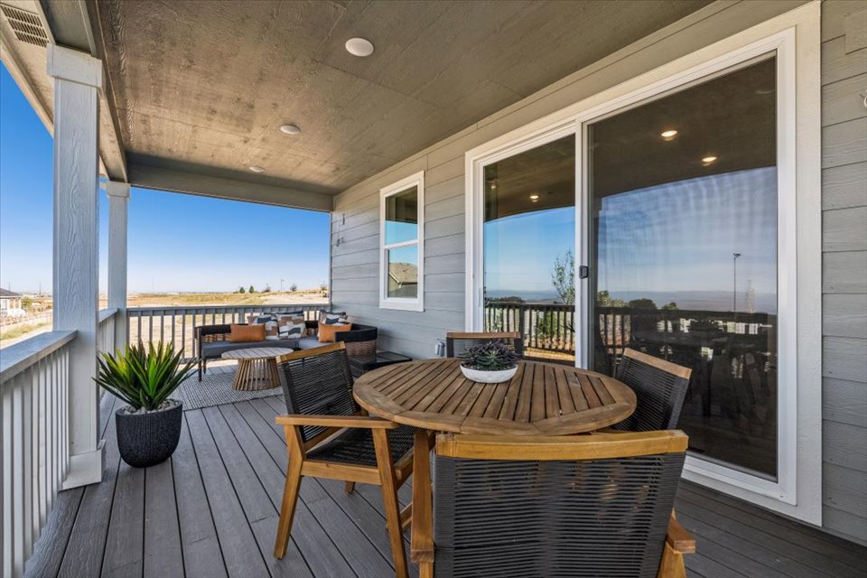 A table and chairs on a deck.