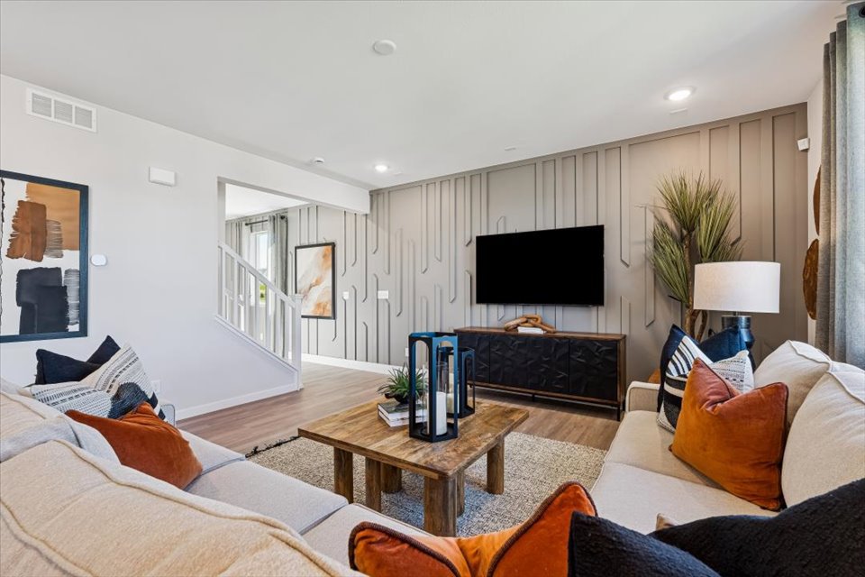 A living room with a tv and couches.