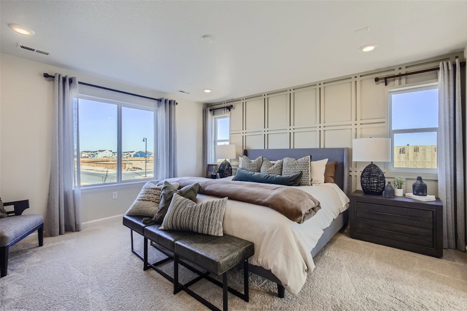 A bedroom with a large window.