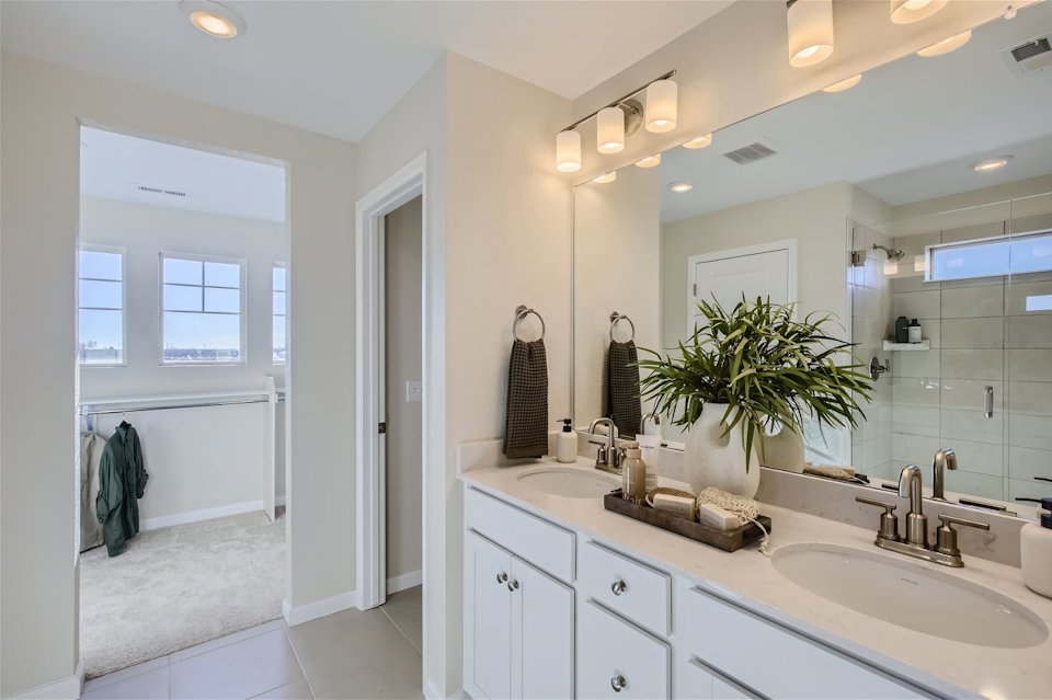 A bathroom with a large mirror.