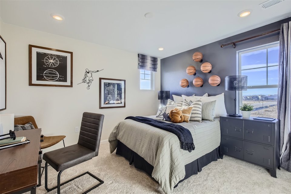 A bedroom with a bed and desk.