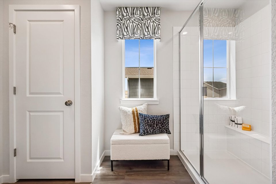 A white bathroom with a glass shower.