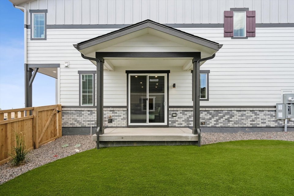 A house with a fence and grass.