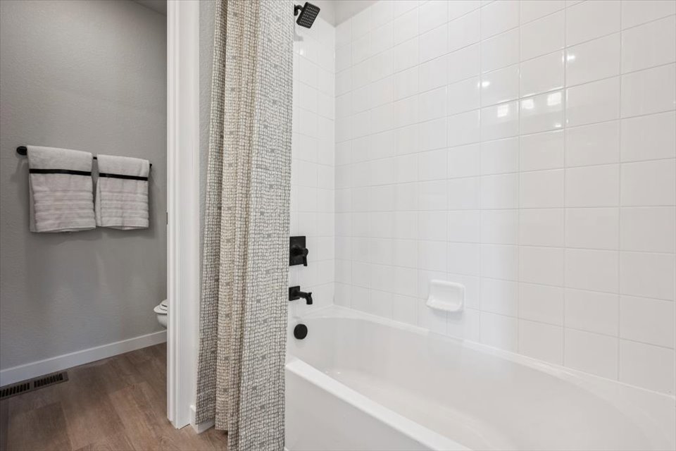 A bathroom with a bathtub and toilet.