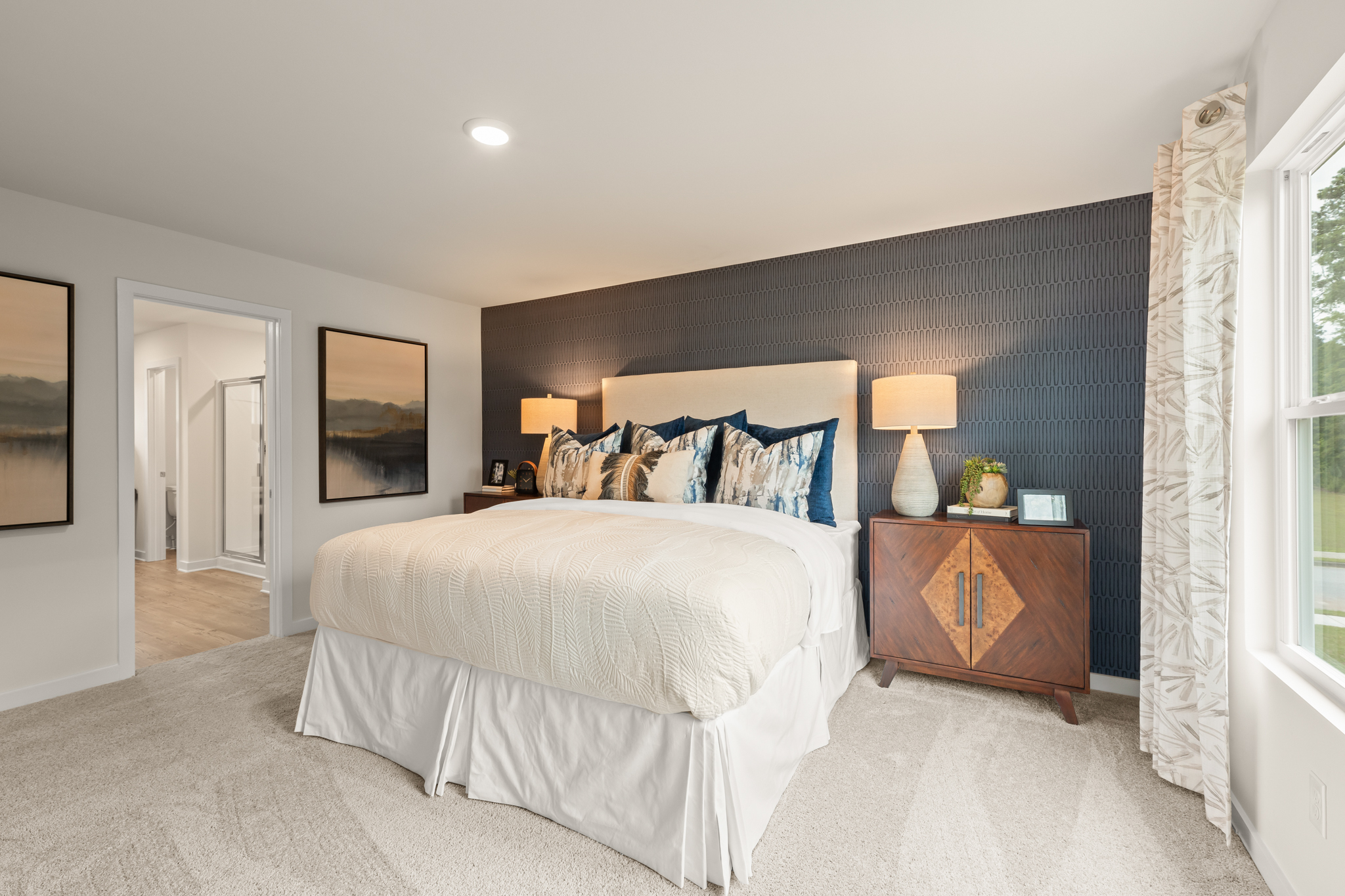 A bedroom with a bed and lamps.