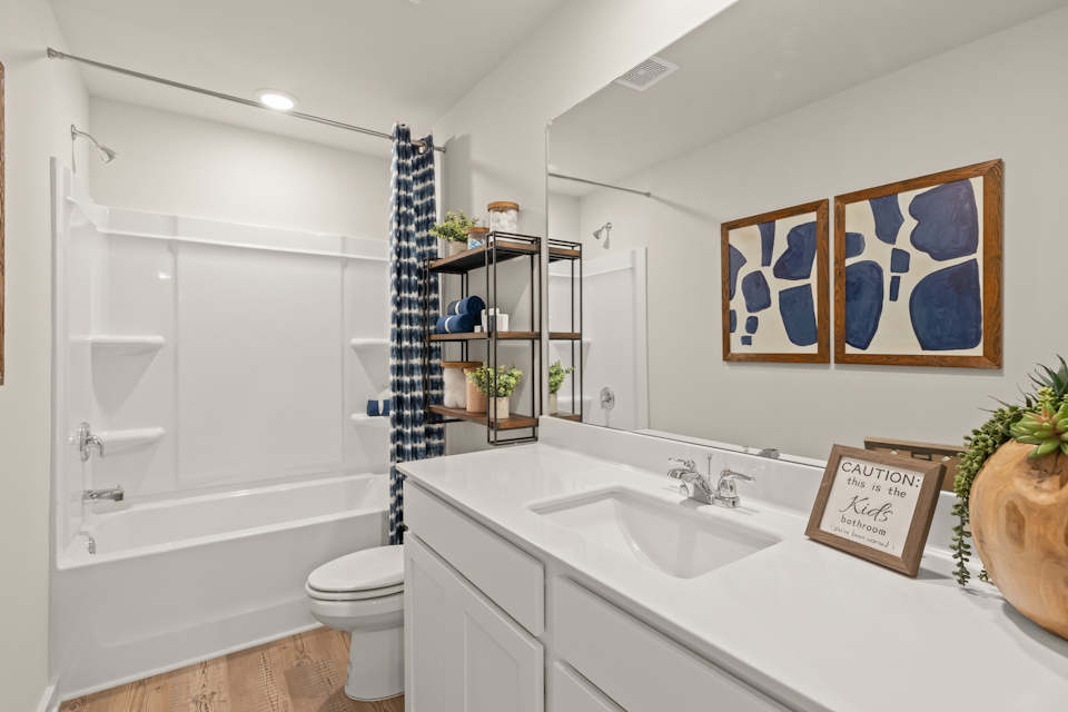 A bathroom with a tub sink and toilet.