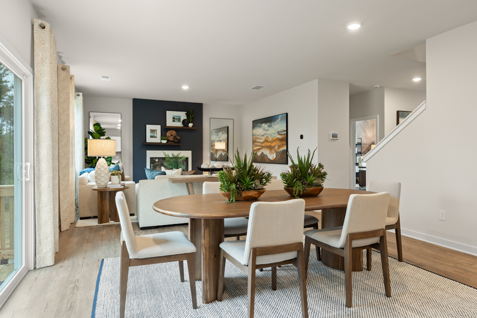 A dining room with a table and chairs.