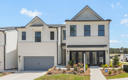 A white house with a garage.