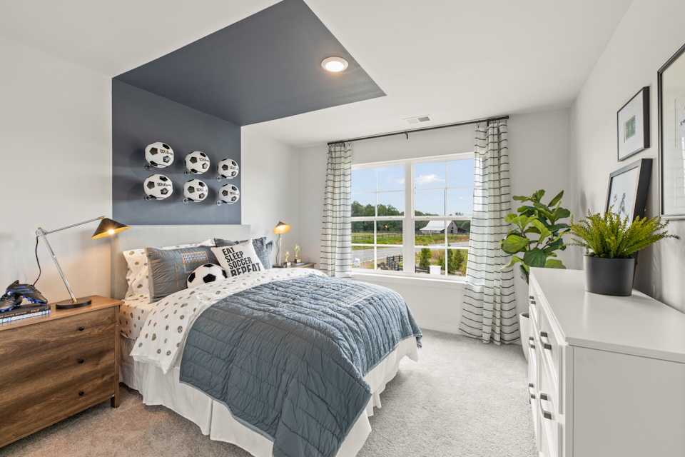 A bedroom with a bed and a window.