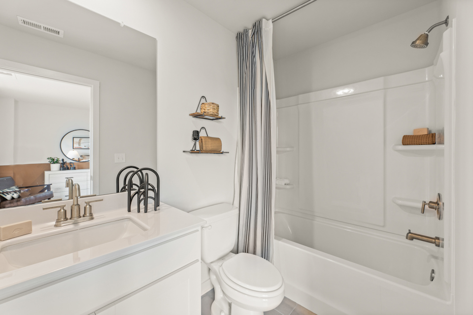 A bathroom with a tub toilet and sink.