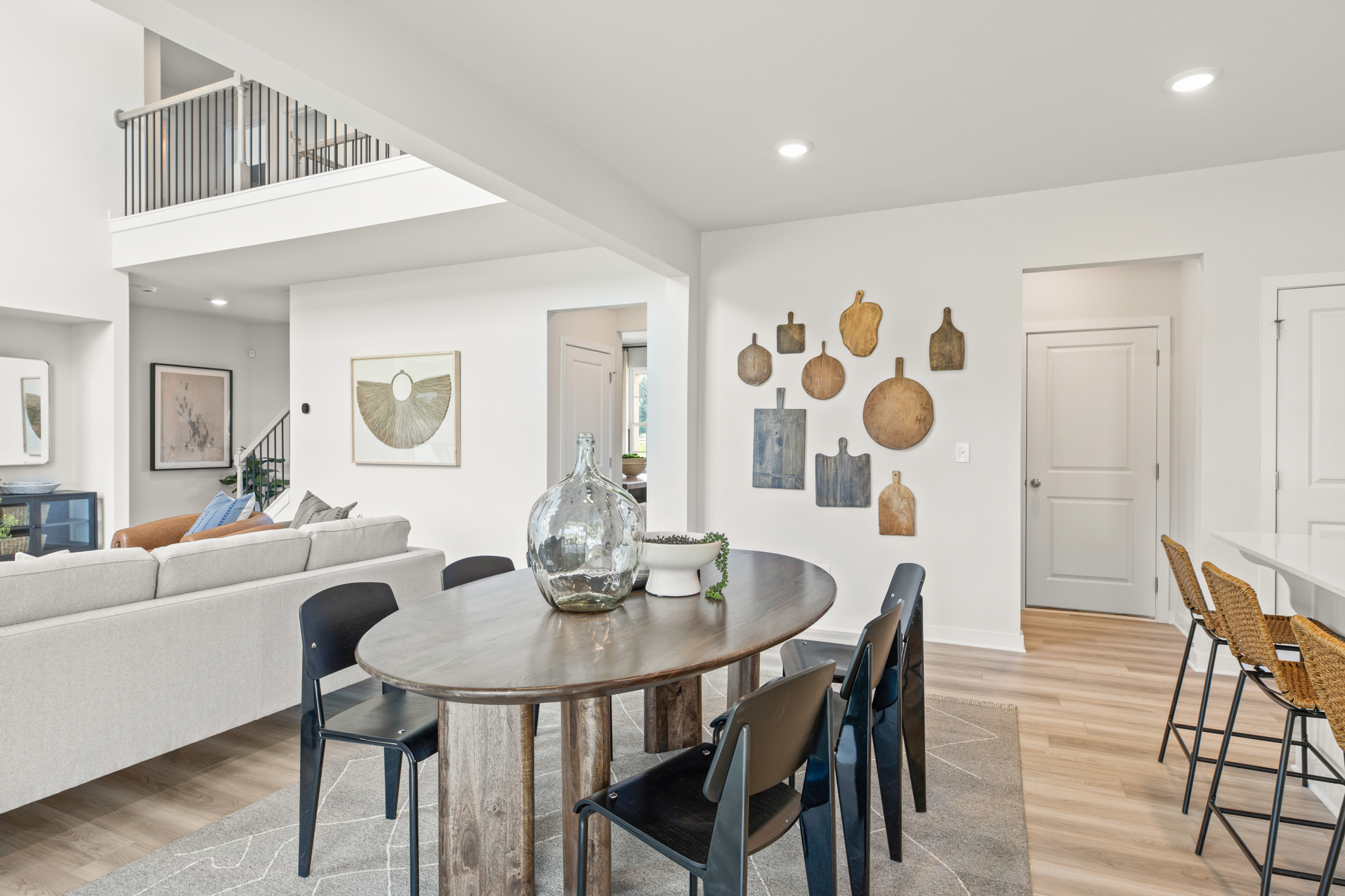 A living room with a table and chairs.