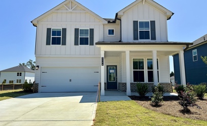 A white house with a driveway.